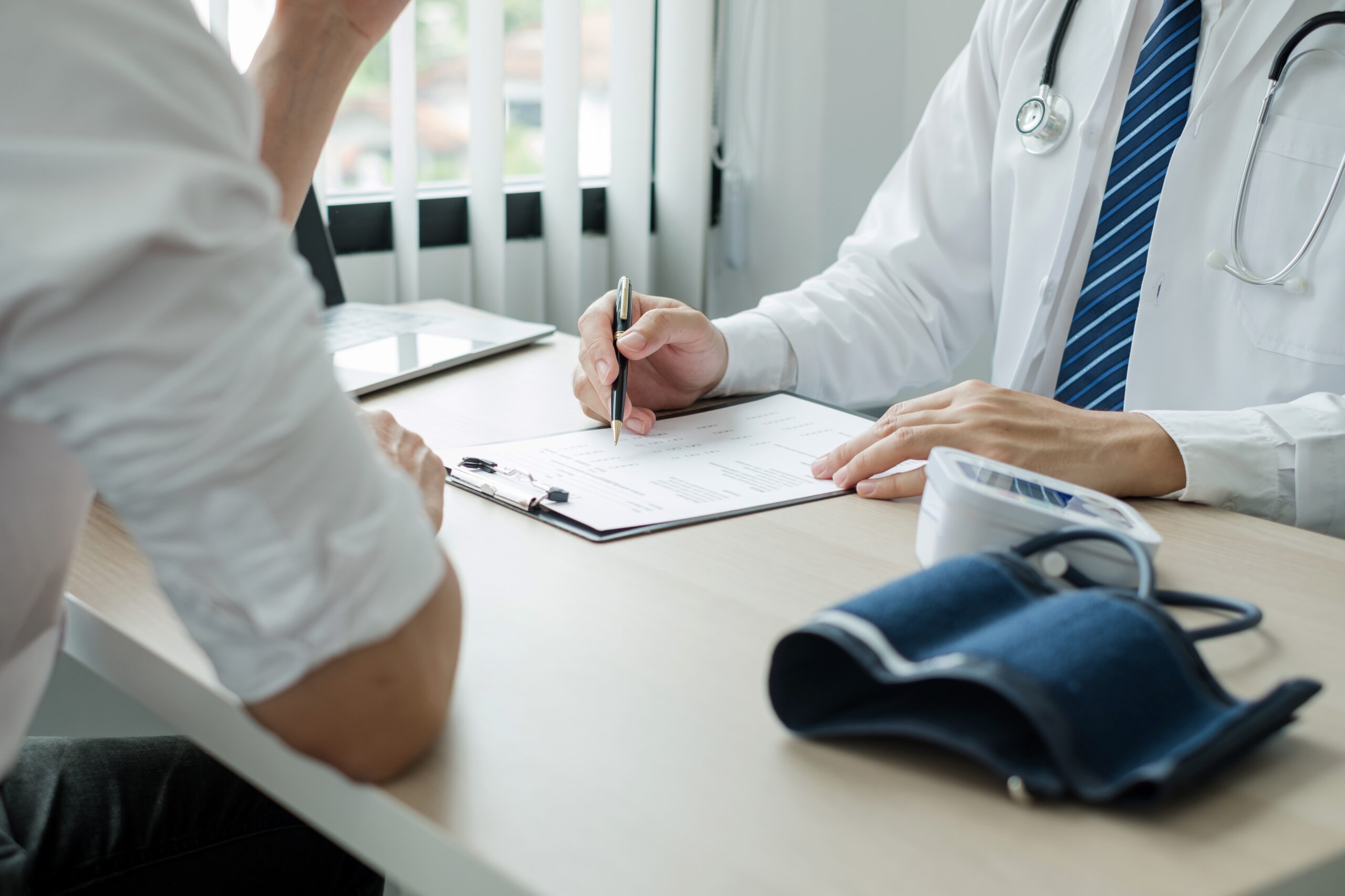 Medical Consultation for Legal Review Doctor reviewing medical records with a patient, illustrating the process of evaluating clinical evidence for legal or expert witness purposes at Med Expert Witness