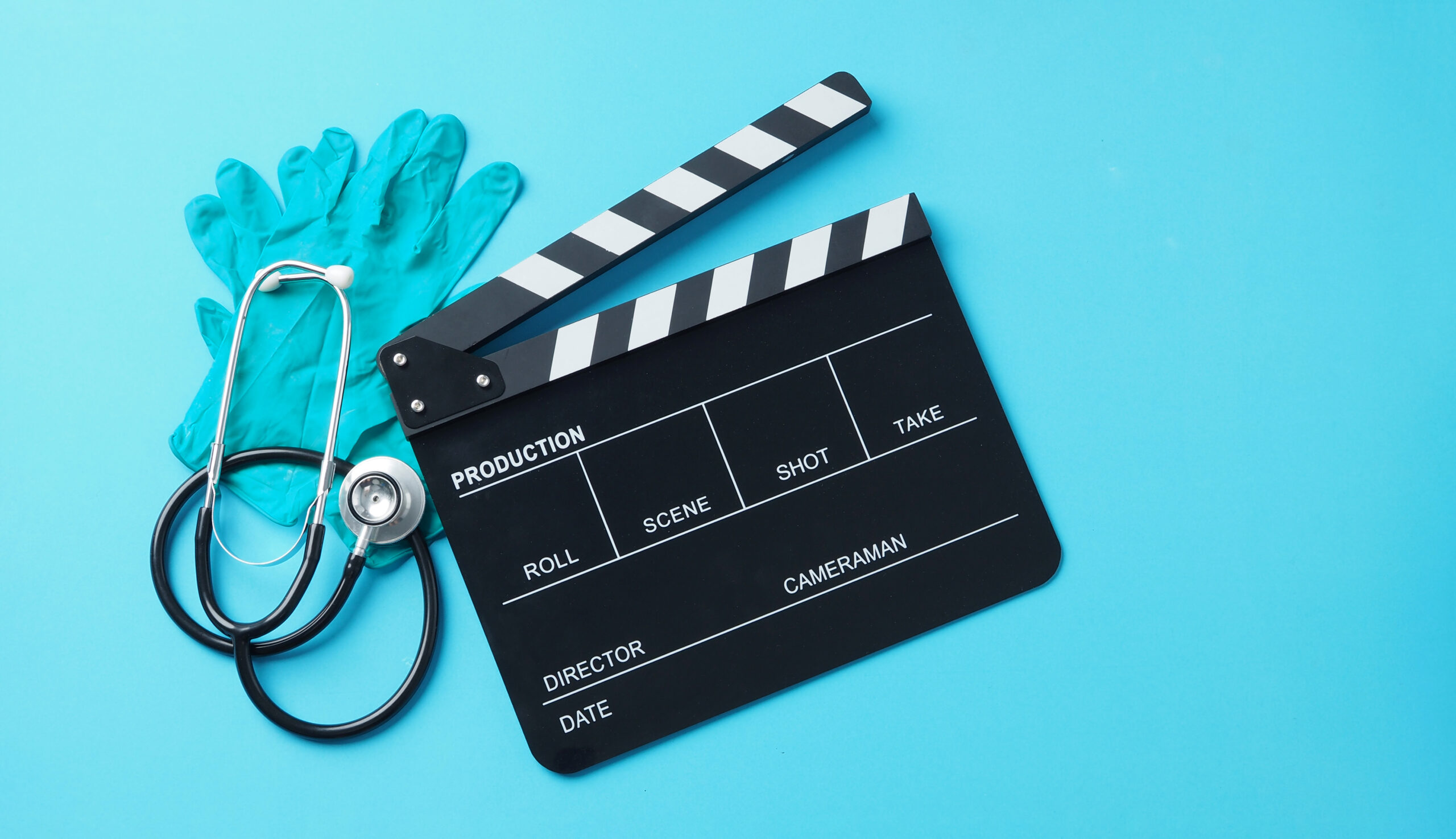 clapperboard and latex glove and Stethoscope on blue background for medical experts